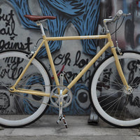 This fixed gear bicycle is called "The Count" and features white rims and a cream frame.