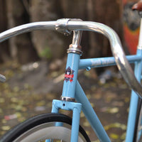 This fixed gear bicycle is called "The Prince" and features white rims and a sky blue frame.