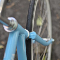This fixed gear bicycle is called "The Prince" and features white rims and a sky blue frame.