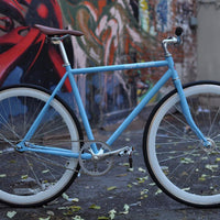 This fixed gear bicycle is called "The Prince" and features white rims and a sky blue frame.