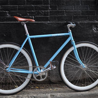 This fixed gear bicycle is called "The Prince" and features white rims and a sky blue frame.
