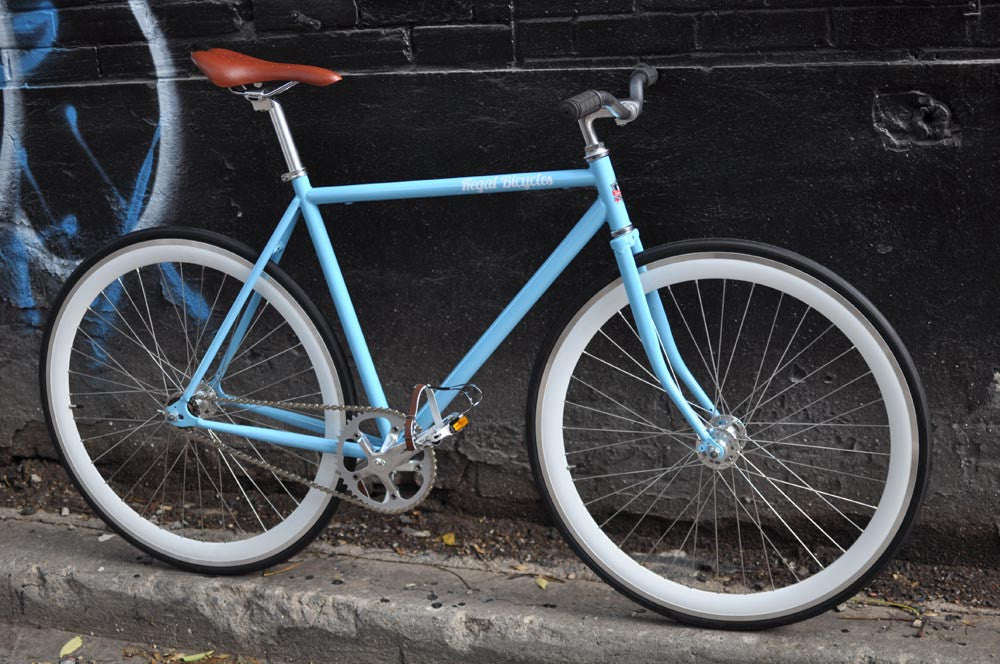 This fixed gear bicycle is called "The Prince" and features white rims and a sky blue frame.