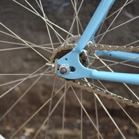 This fixed gear bicycle is called "The Prince" and features white rims and a sky blue frame.