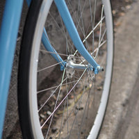 This fixed gear bicycle is called "The Prince" and features white rims and a sky blue frame.