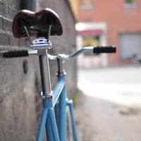 This fixed gear bicycle is called "The Prince" and features white rims and a sky blue frame.