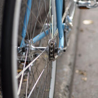 This fixed gear bicycle is called "The Prince" and features white rims and a sky blue frame.