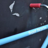 This fixed gear bicycle is called "The Maquis" and features red rims and a sky blue frame.