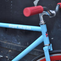 This fixed gear bicycle is called "The Maquis" and features red rims and a sky blue frame.