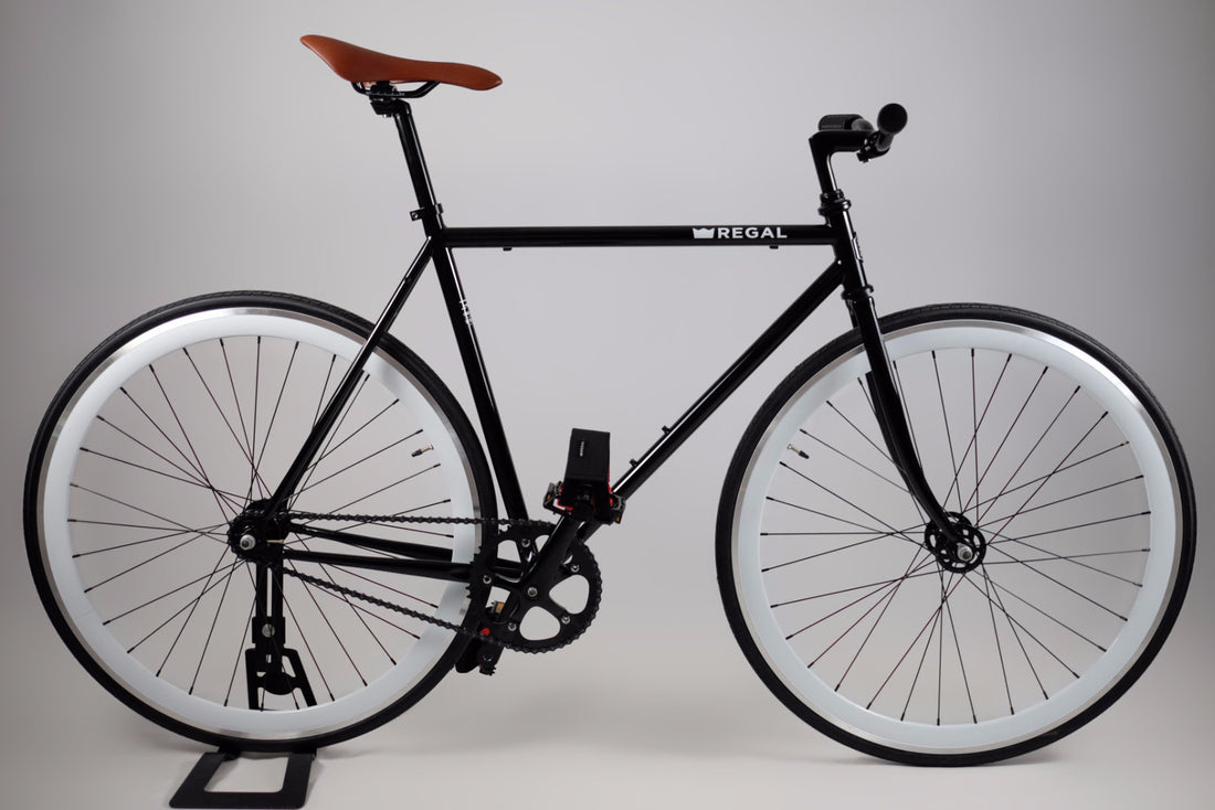 The Duke is a Black Framed Single Speed Bike that can also be ridden as a single speed bike, it has white wall rims 40 MM deep and comes with Regal's fabric pedal straps