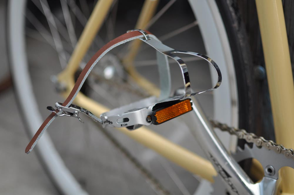 This fixed gear bicycle is called "The Count" and features white rims and a cream frame.