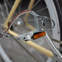 This fixed gear bicycle is called "The Count" and features white rims and a cream frame.