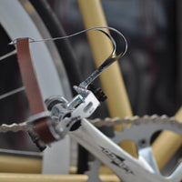 This fixed gear bicycle is called "The Count" and features white rims and a cream frame.