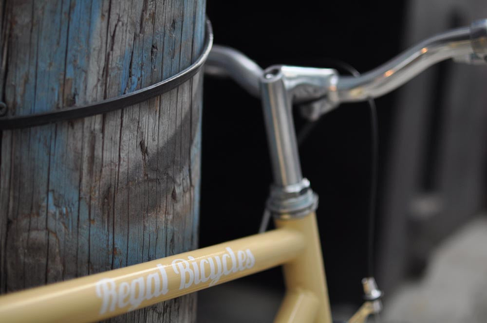 This fixed gear bicycle is called "The Count" and features white rims and a cream frame.