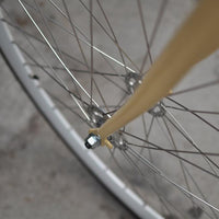 This fixed gear bicycle is called "The Count" and features white rims and a cream frame.