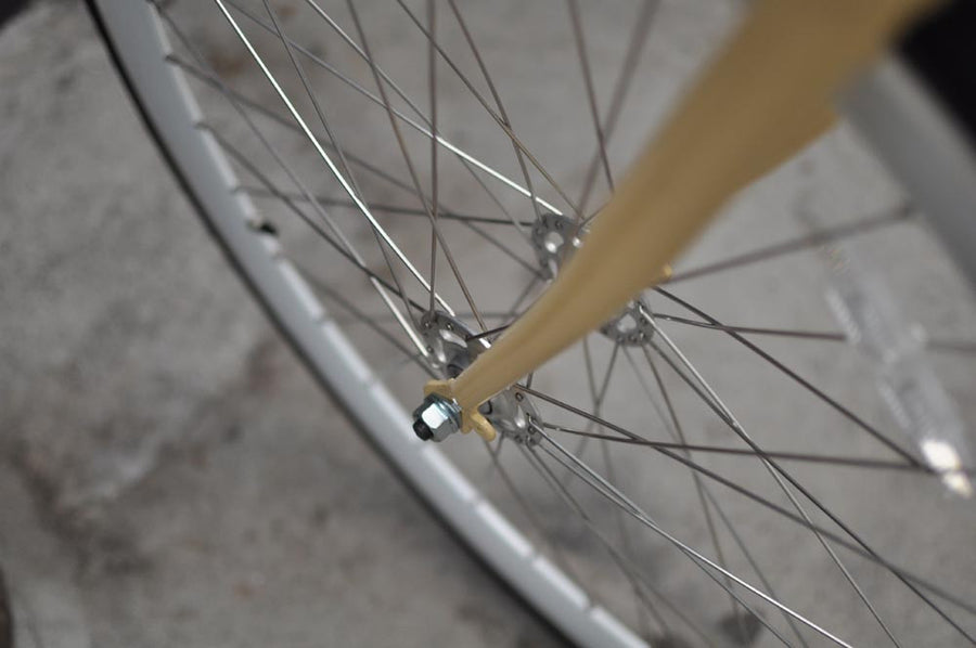 This fixed gear bicycle is called "The Count" and features white rims and a cream frame.