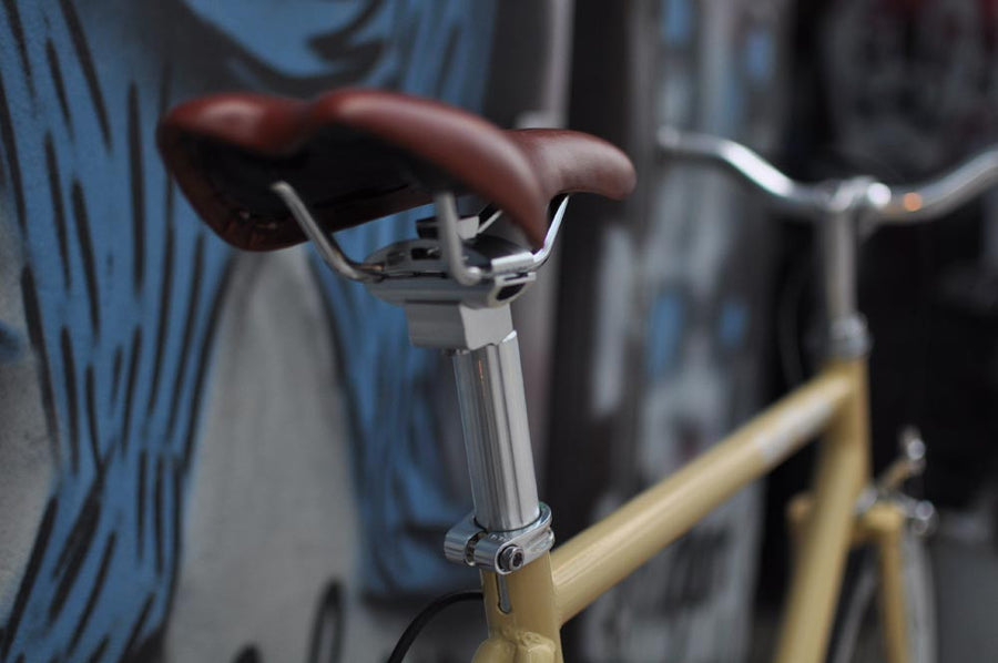 This fixed gear bicycle is called "The Count" and features white rims and a cream frame.