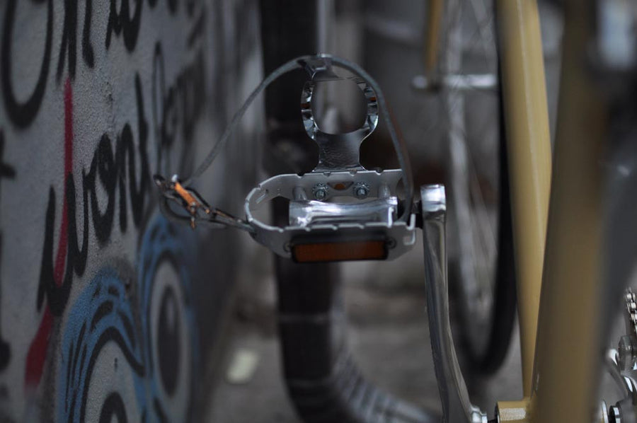 This fixed gear bicycle is called "The Count" and features white rims and a cream frame.