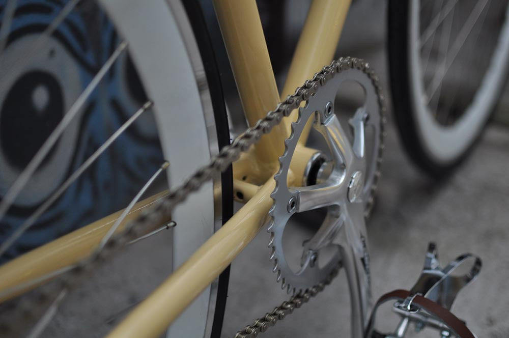 This fixed gear bicycle is called "The Count" and features white rims and a cream frame.