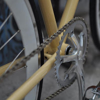 This fixed gear bicycle is called "The Count" and features white rims and a cream frame.