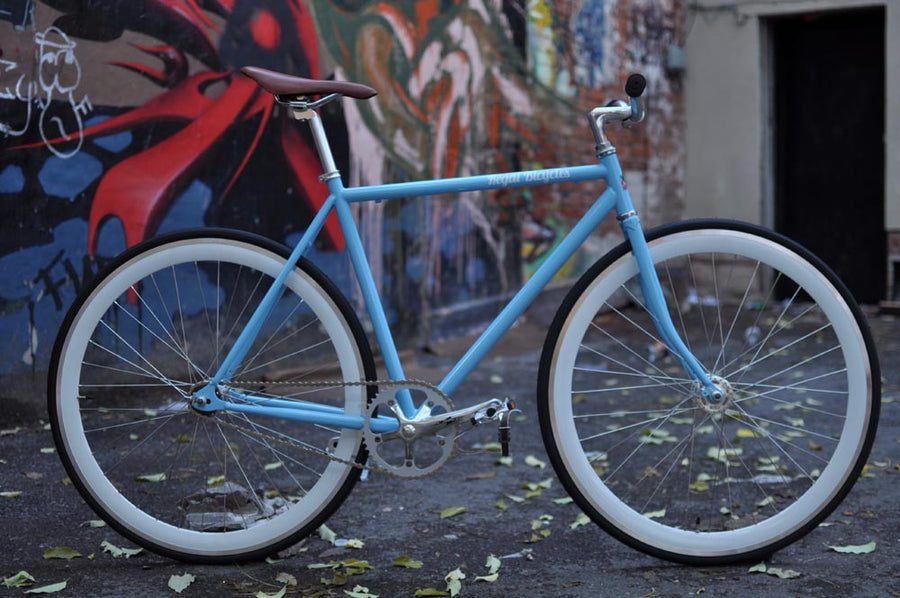 This fixed gear bicycle is called "The Prince" and features white rims and a sky blue frame.