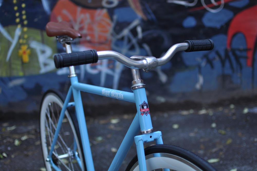 This fixed gear bicycle is called "The Prince" and features white rims and a sky blue frame.