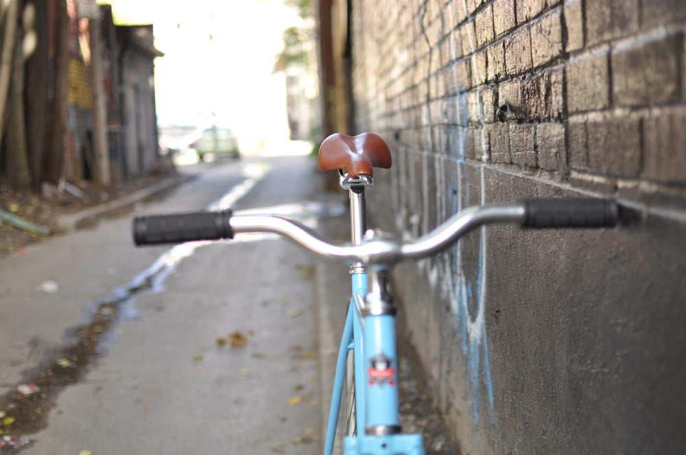 This fixed gear bicycle is called "The Prince" and features white rims and a sky blue frame.