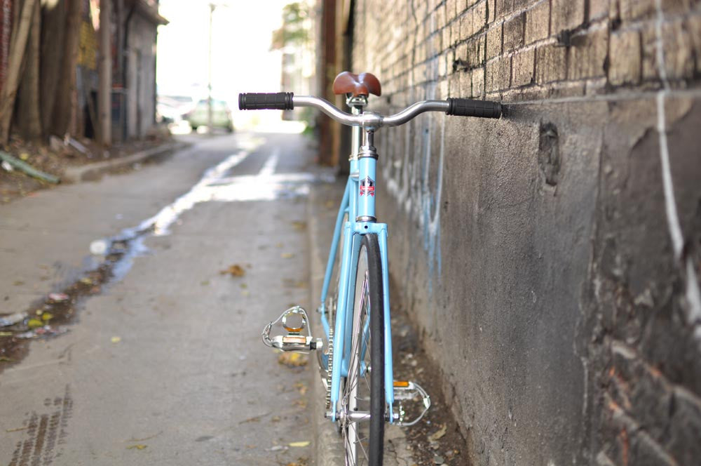 This fixed gear bicycle is called "The Prince" and features white rims and a sky blue frame.