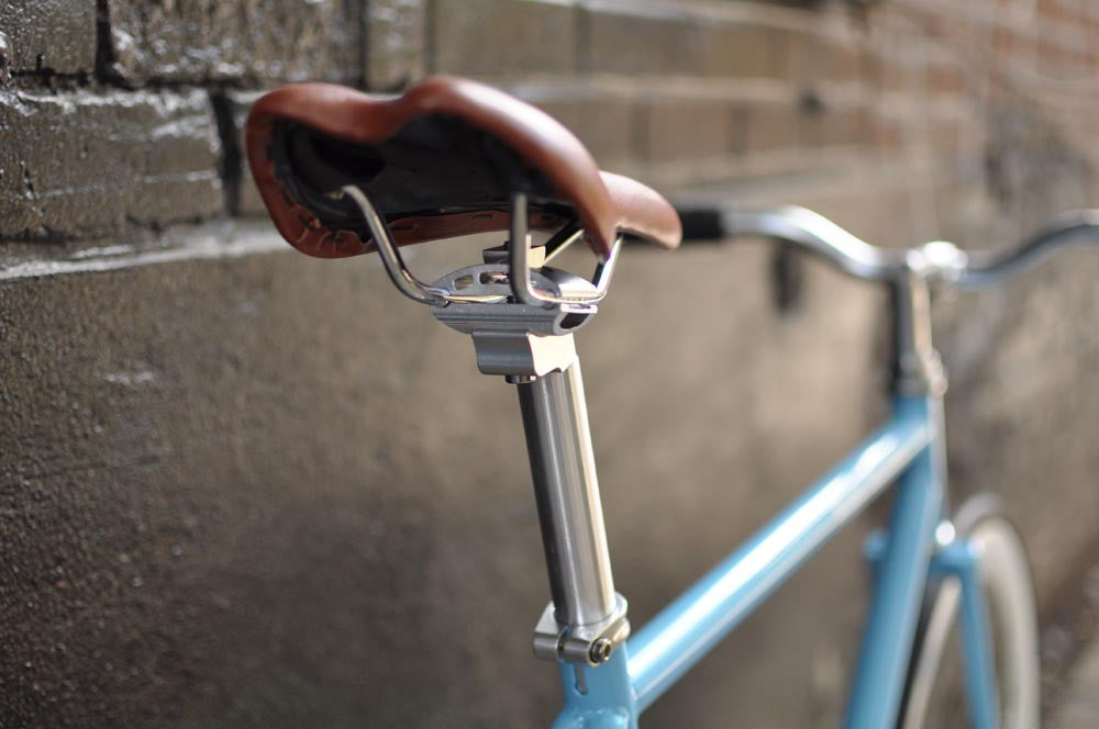 This fixed gear bicycle is called "The Prince" and features white rims and a sky blue frame.