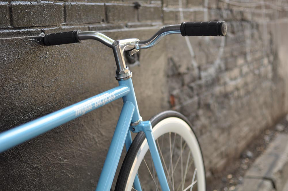 This fixed gear bicycle is called "The Prince" and features white rims and a sky blue frame.