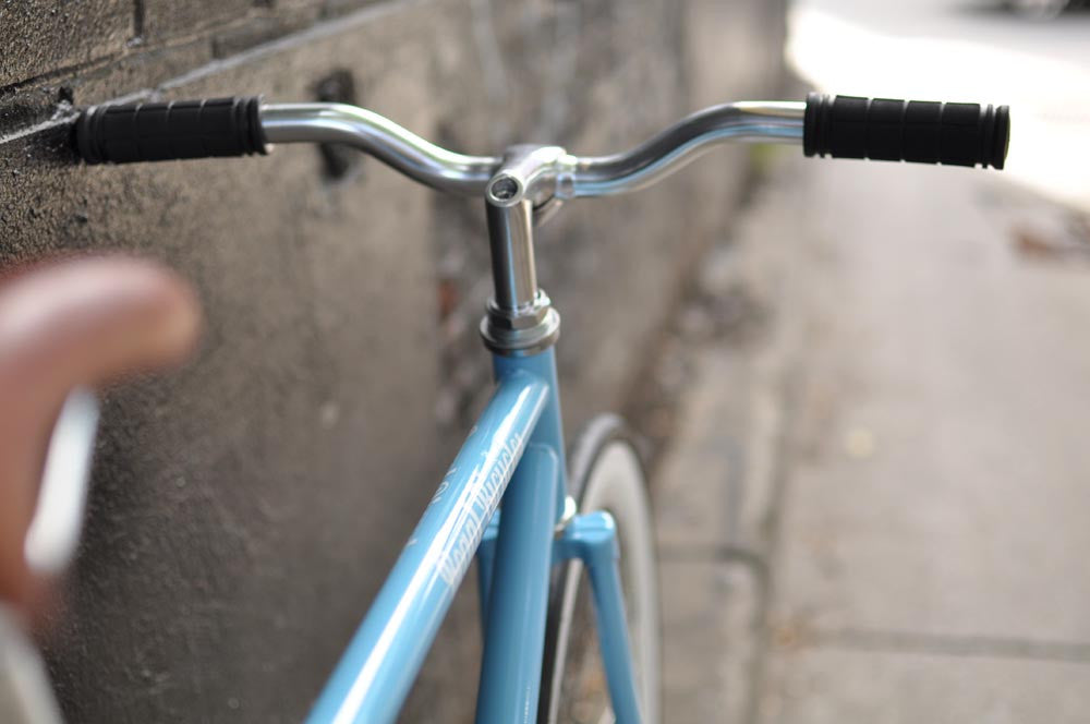 This fixed gear bicycle is called "The Prince" and features white rims and a sky blue frame.