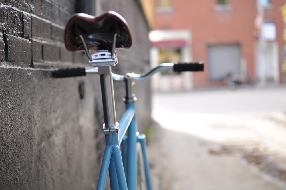 This fixed gear bicycle is called "The Prince" and features white rims and a sky blue frame.