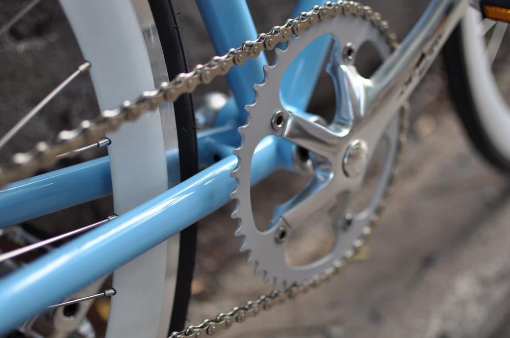 This fixed gear bicycle is called "The Prince" and features white rims and a sky blue frame.