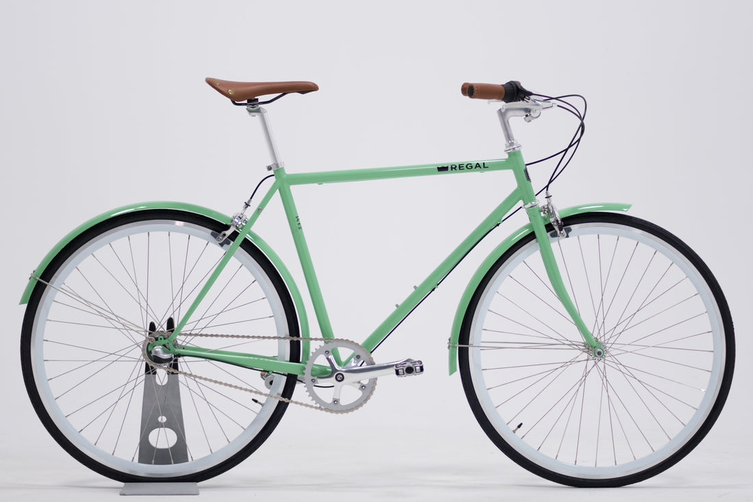 City Bike by Regal Bicycles with a Mint Green Frame and White Wall Rims, featuring a Shimano Nexus 3 Speed Internal Gear Hub built for commuting